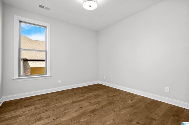 unfurnished room featuring dark hardwood / wood-style floors