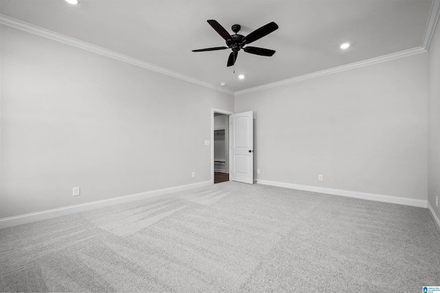 empty room with ceiling fan, ornamental molding, and carpet floors