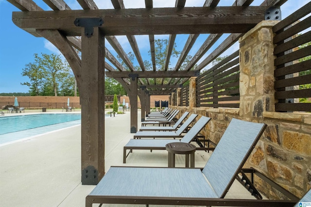 view of patio / terrace with a community pool and a pergola