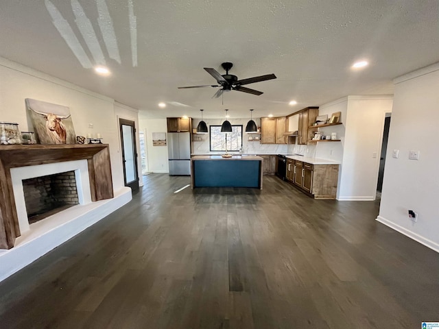 kitchen with stainless steel refrigerator, hanging light fixtures, crown molding, decorative backsplash, and a kitchen island