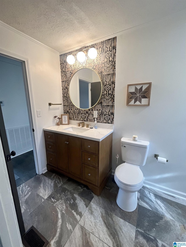 bathroom with toilet, crown molding, a textured ceiling, and vanity