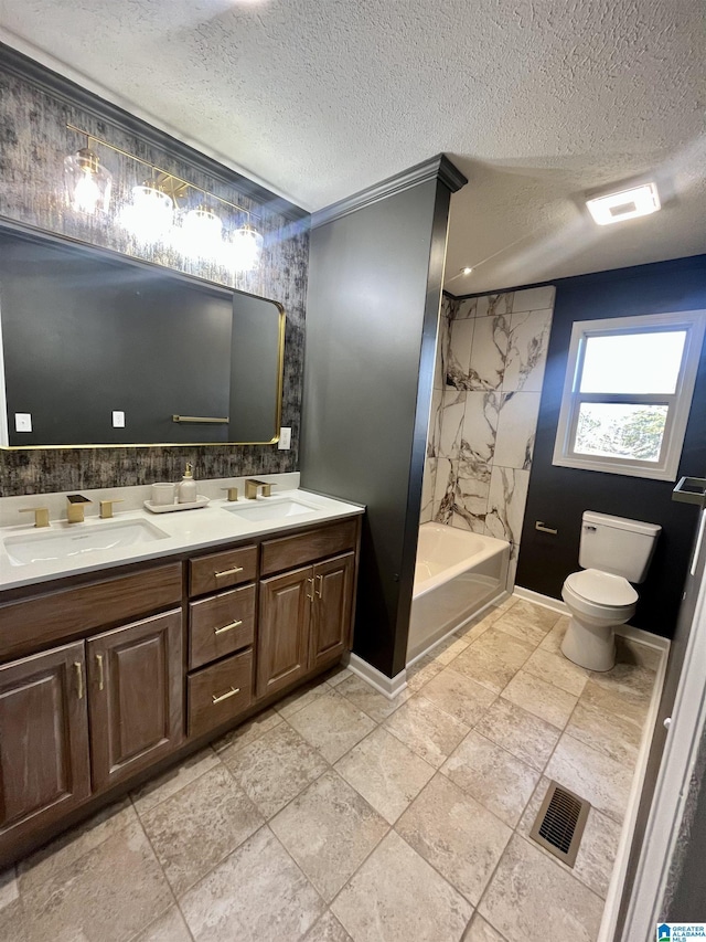 full bathroom with tiled shower / bath combo, crown molding, a textured ceiling, toilet, and vanity