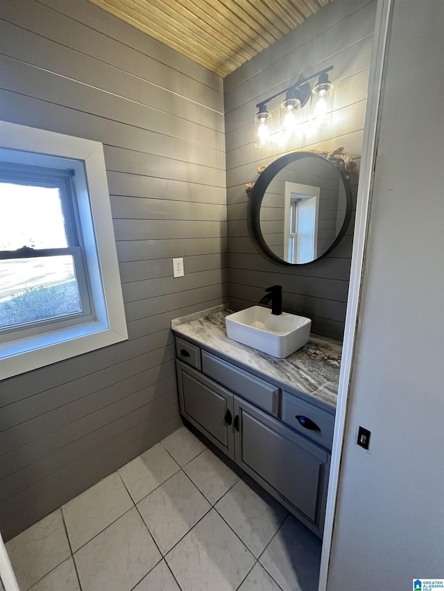 bathroom with tile patterned flooring, vanity, and wooden ceiling