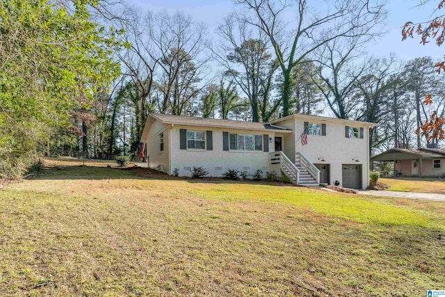 tri-level home featuring a garage and a front lawn