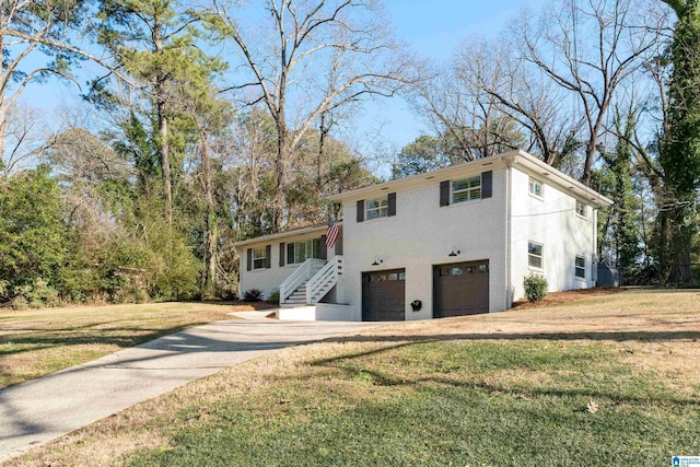 view of front of home with a garage and a front lawn