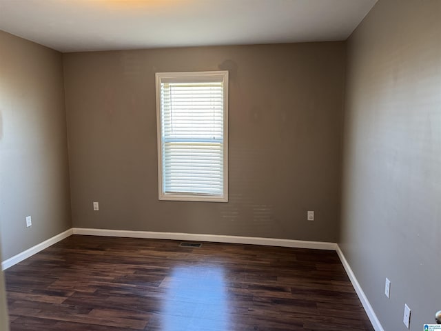 unfurnished room with dark hardwood / wood-style floors