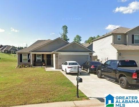 view of front of home featuring a front yard and a garage