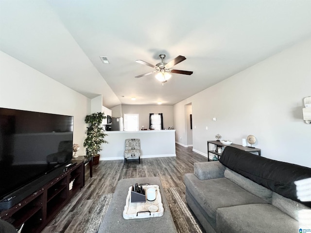 living room featuring dark hardwood / wood-style flooring, vaulted ceiling, and ceiling fan