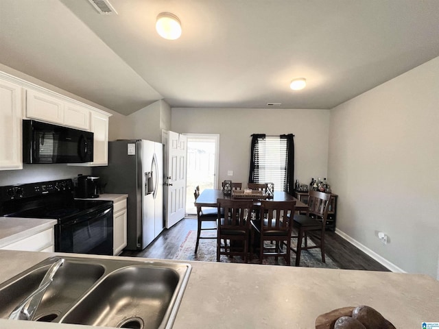 kitchen featuring black appliances, dark hardwood / wood-style floors, white cabinetry, and sink