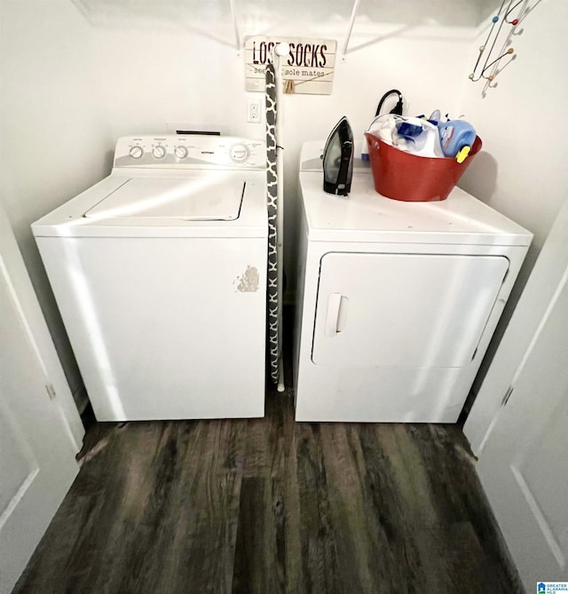 washroom with dark hardwood / wood-style floors and washing machine and clothes dryer