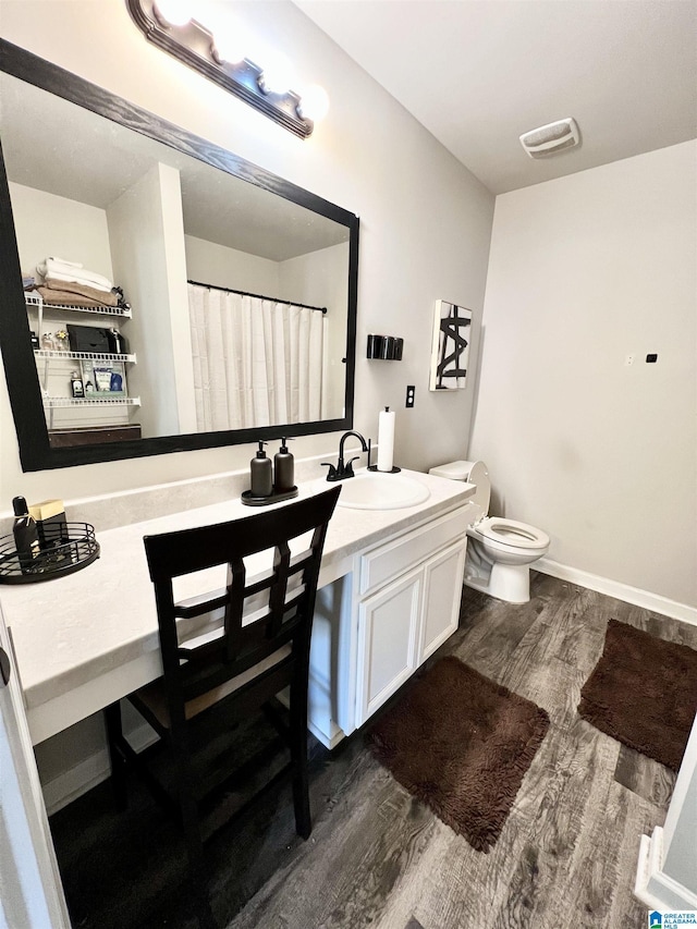 bathroom featuring hardwood / wood-style floors, vanity, and toilet