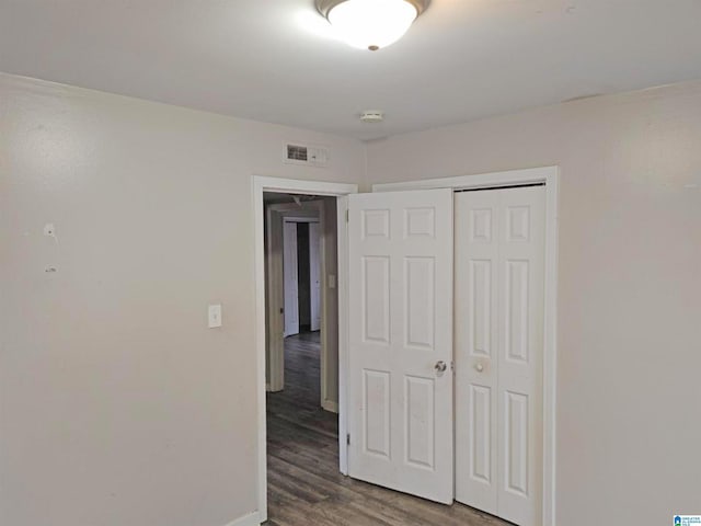 unfurnished bedroom featuring a closet and hardwood / wood-style floors