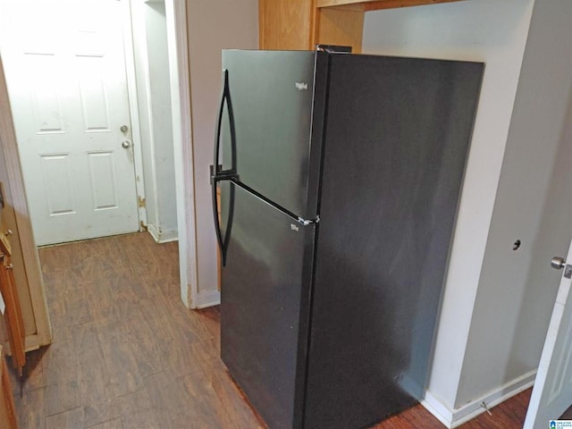 kitchen with hardwood / wood-style flooring and stainless steel refrigerator