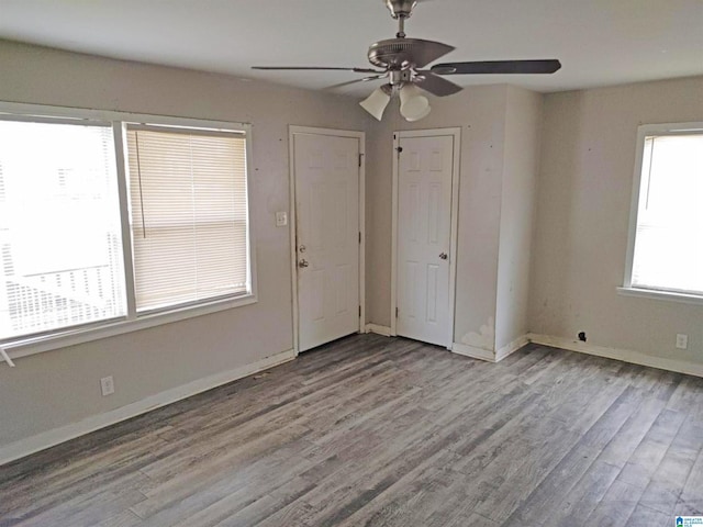 unfurnished bedroom with ceiling fan and light wood-type flooring