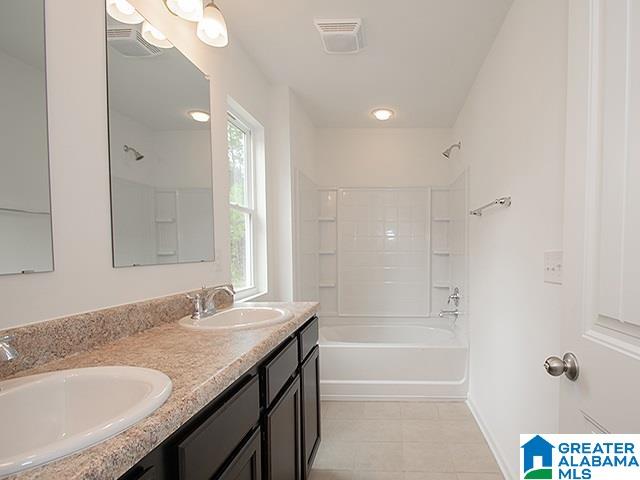 bathroom with vanity and tub / shower combination