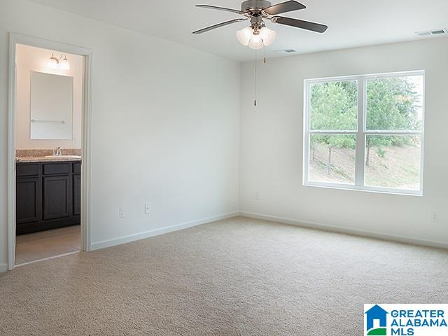 unfurnished room featuring ceiling fan and light colored carpet