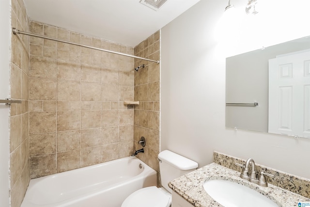 full bathroom with vanity, toilet, and tiled shower / bath