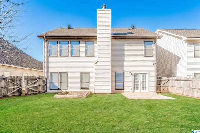 back of house featuring a yard and a patio