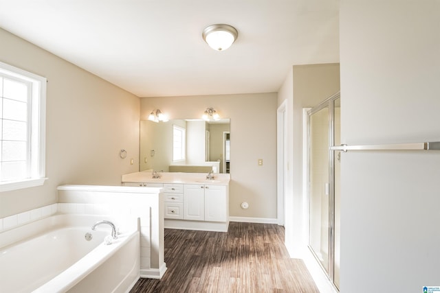 bathroom featuring wood-type flooring, vanity, separate shower and tub, and plenty of natural light