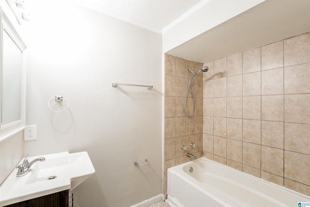 bathroom featuring vanity, ornamental molding, and tiled shower / bath combo