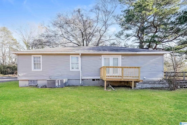 back of house with a lawn, cooling unit, a deck, and french doors