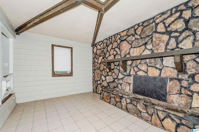 unfurnished living room with a textured ceiling, lofted ceiling with beams, and wooden walls