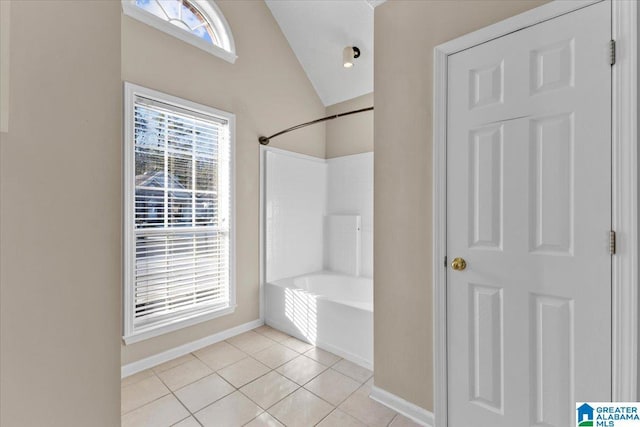 bathroom with tile patterned flooring and vaulted ceiling