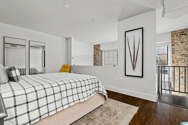 bedroom featuring access to outside and dark wood-type flooring