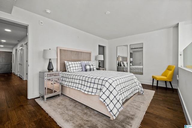 bedroom with dark hardwood / wood-style floors