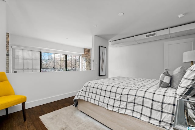 bedroom with dark hardwood / wood-style flooring