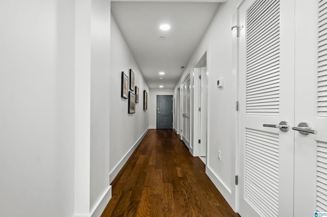 corridor with dark hardwood / wood-style floors