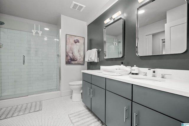 bathroom featuring tile patterned flooring, vanity, an enclosed shower, and toilet