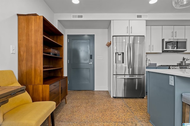 kitchen with white cabinetry and appliances with stainless steel finishes