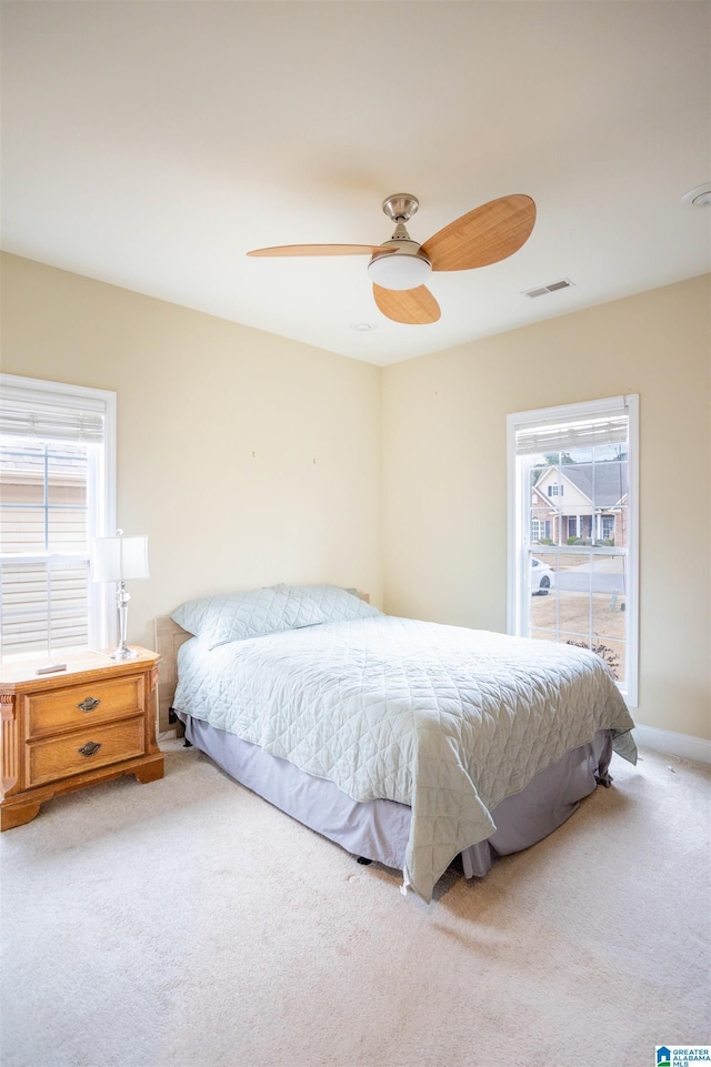 carpeted bedroom with ceiling fan