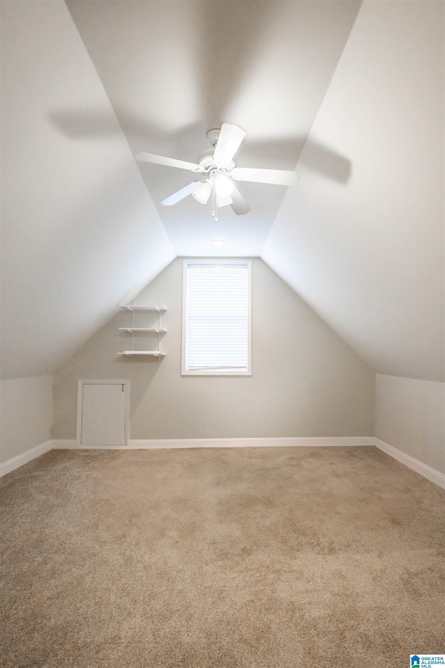 additional living space with carpet, ceiling fan, and vaulted ceiling