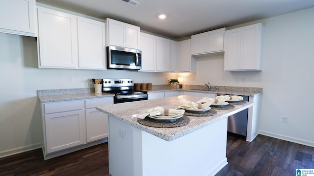 kitchen featuring white cabinets, stainless steel appliances, and sink