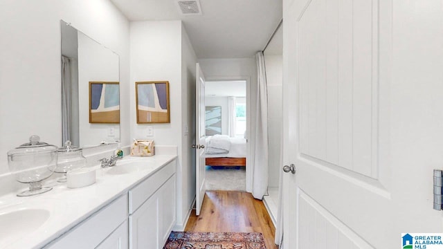 bathroom featuring hardwood / wood-style flooring and vanity