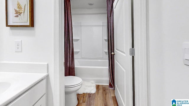 full bathroom featuring vanity, wood-type flooring, shower / bath combo, and toilet