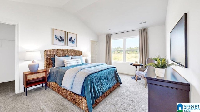 carpeted bedroom featuring vaulted ceiling