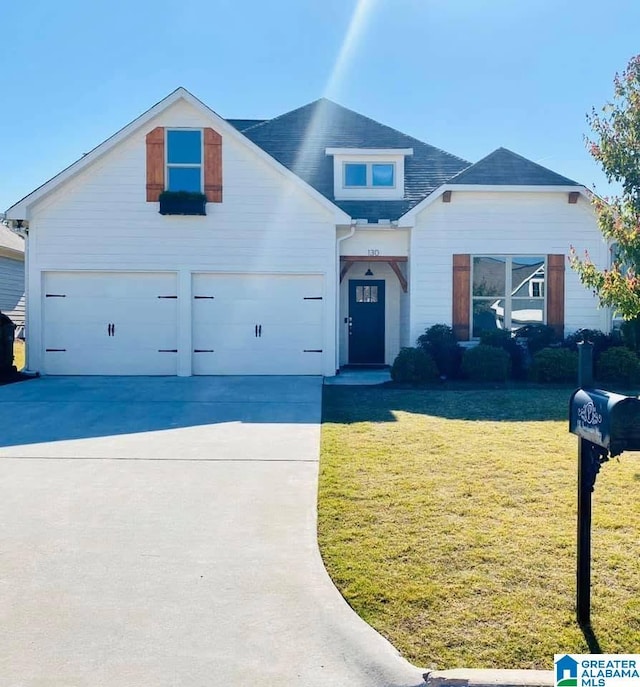 view of front of house featuring a front lawn and a garage