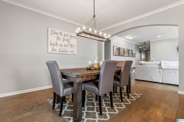 dining room featuring dark hardwood / wood-style floors, an inviting chandelier, and ornamental molding