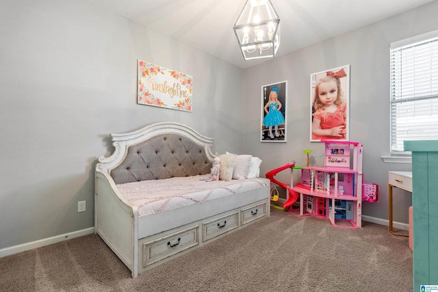 bedroom with carpet floors and a notable chandelier