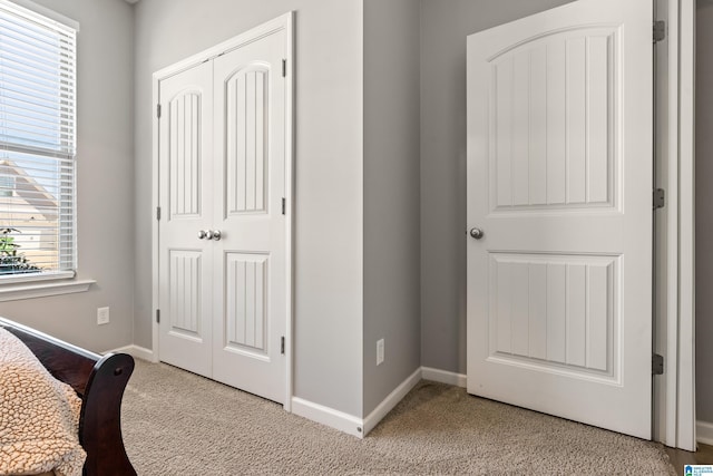 bedroom featuring light colored carpet