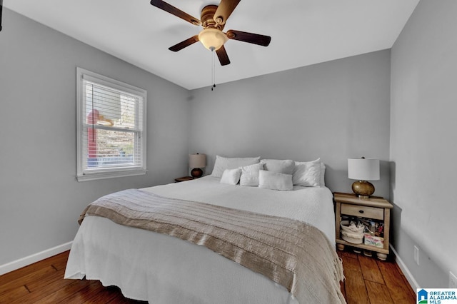 bedroom with ceiling fan and dark hardwood / wood-style floors