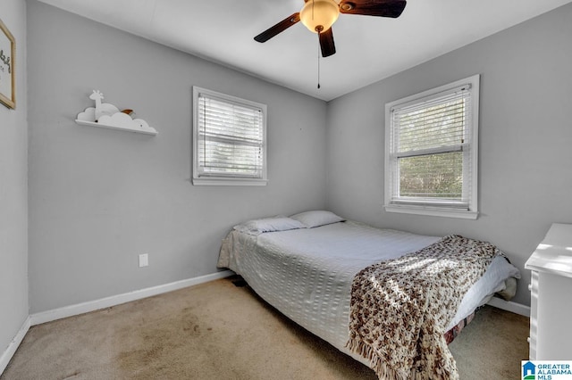 bedroom with ceiling fan and light carpet