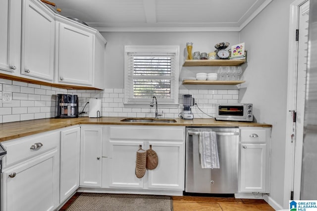 kitchen with white cabinetry, dishwasher, sink, tasteful backsplash, and wooden counters