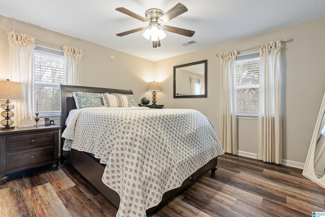 bedroom with ceiling fan and dark hardwood / wood-style flooring