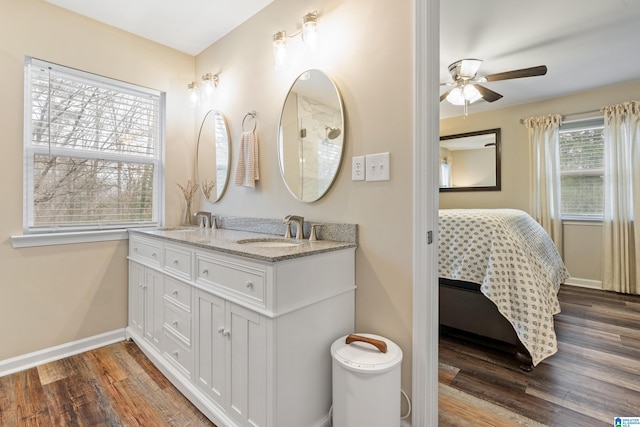 bathroom with ceiling fan, vanity, and wood-type flooring