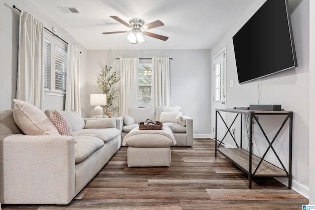 living room featuring dark hardwood / wood-style floors and ceiling fan