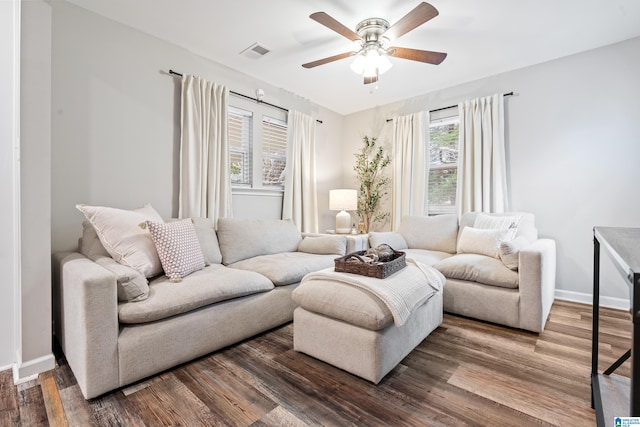 living room with wood-type flooring, ceiling fan, and a healthy amount of sunlight